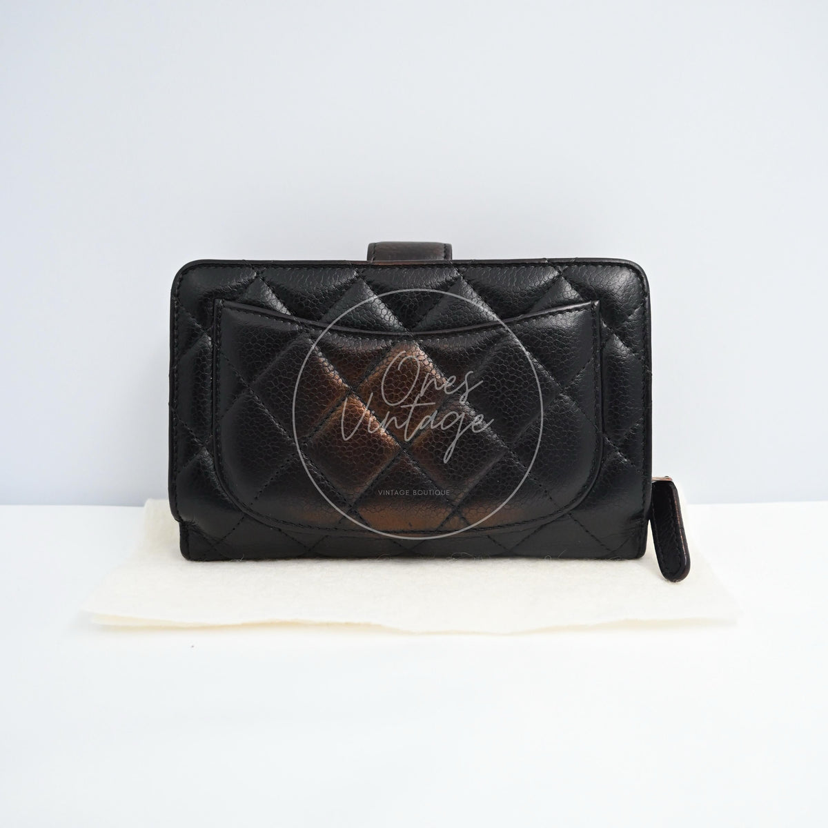 Chanel Bifold Medium Caviar Wallet With in black caviar leather with palladium hardware, featuring front flap pocket and side zipper pull, front view