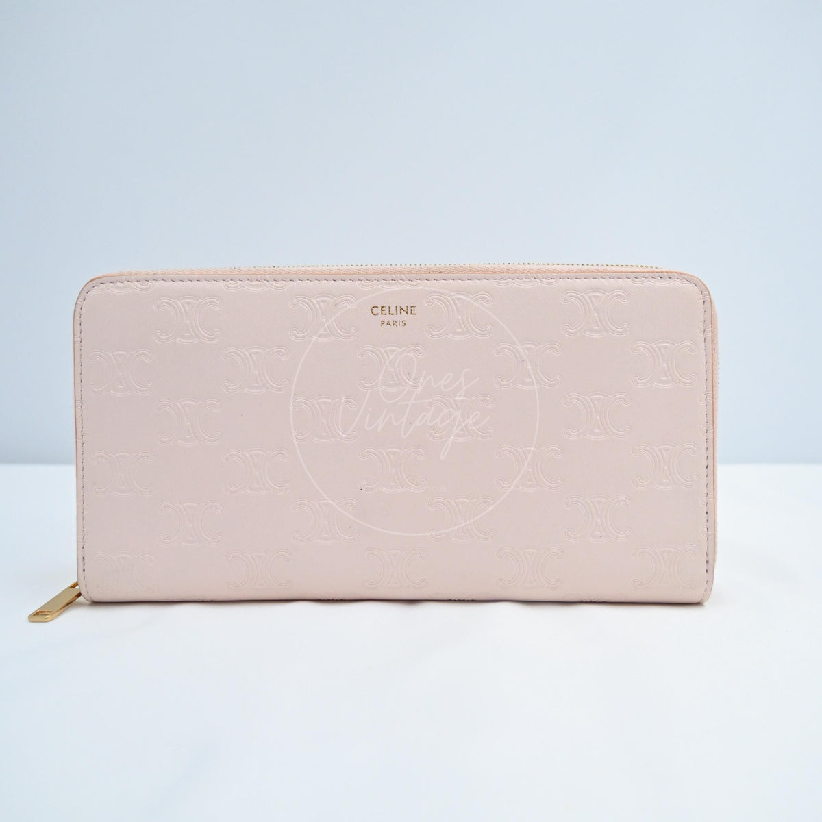 Celine Triomphe Embossed Calfskin Zippy Long Wallet in pink lambskin, featuring embossed repeating motif and top-edge zipper, front view