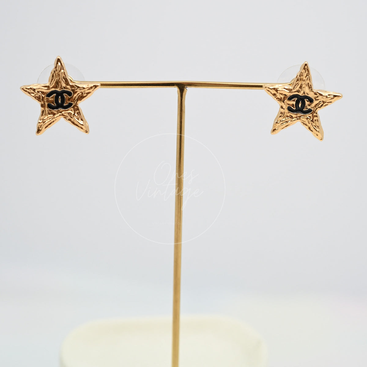 Chanel CC Mark on Gold Lava Star earrings in gold-plated alloy metal, featuring paired star-shaped earrings and black CC motifs, front view