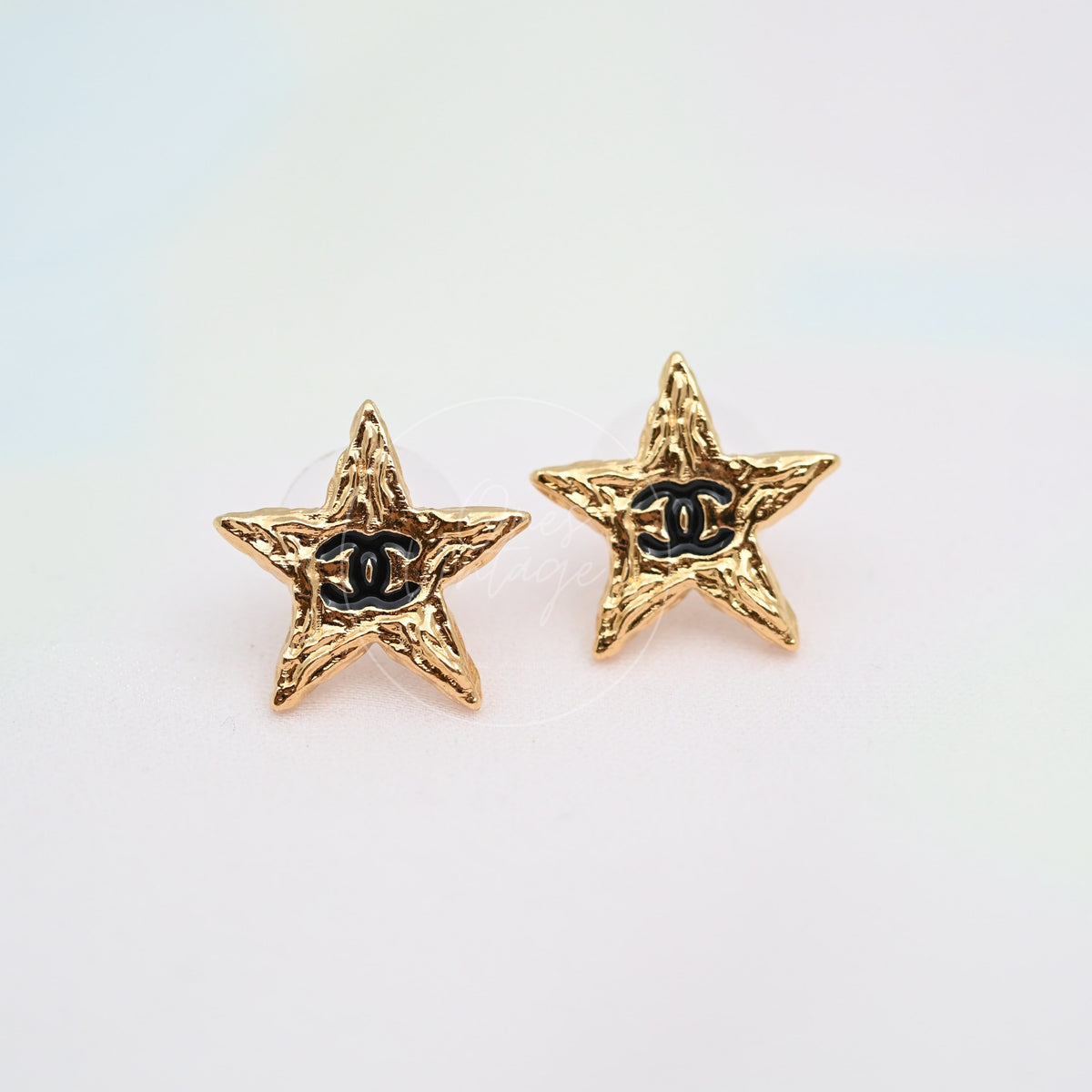 Chanel CC Mark on Gold Lava Star earrings in gold-plated alloy metal, featuring star-shaped earrings and black CC emblem, front view