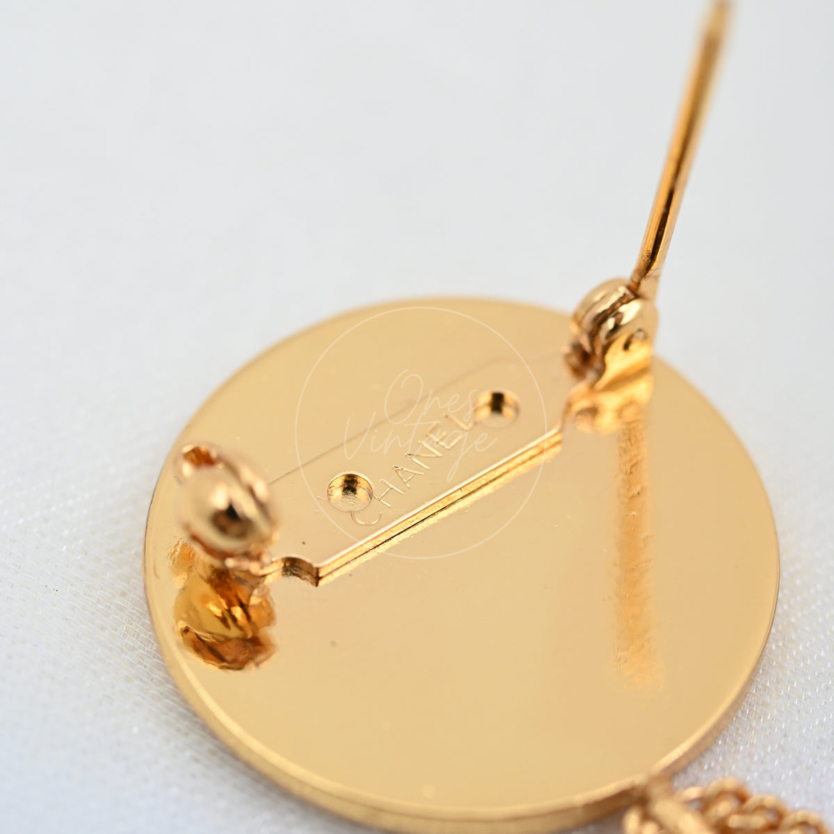 Chanel Vintage CC Medallion Flap Bag Brooch in 24K gold-plated, featuring pin-and-roll clasp and circular polished reverse, back view