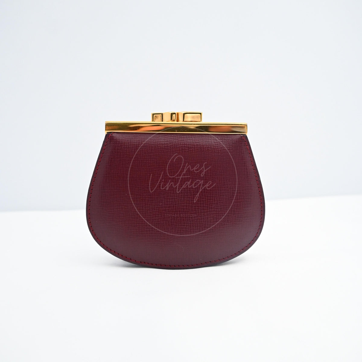 Cartier Mastline Bordeaux CalfskinCoin Case in burgundy calfskin, featuring top clasp closure and rounded coin case silhouette, front view