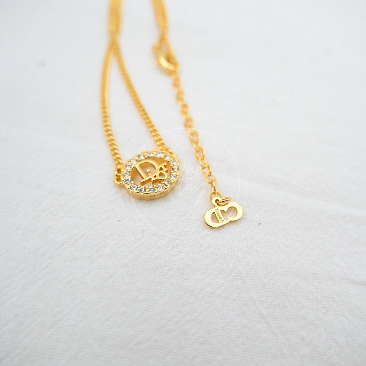 Dior Crystal-embellished Logo-pendant Necklace, circular logo pendant and rhinestone-encrusted border detail