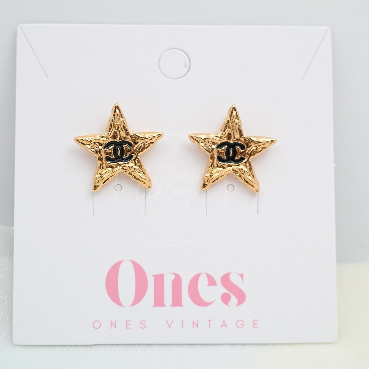 Chanel CC Mark on Gold Lava Star earrings in gold-plated alloy metal, featuring star-shaped earrings and black CC motifs, front view