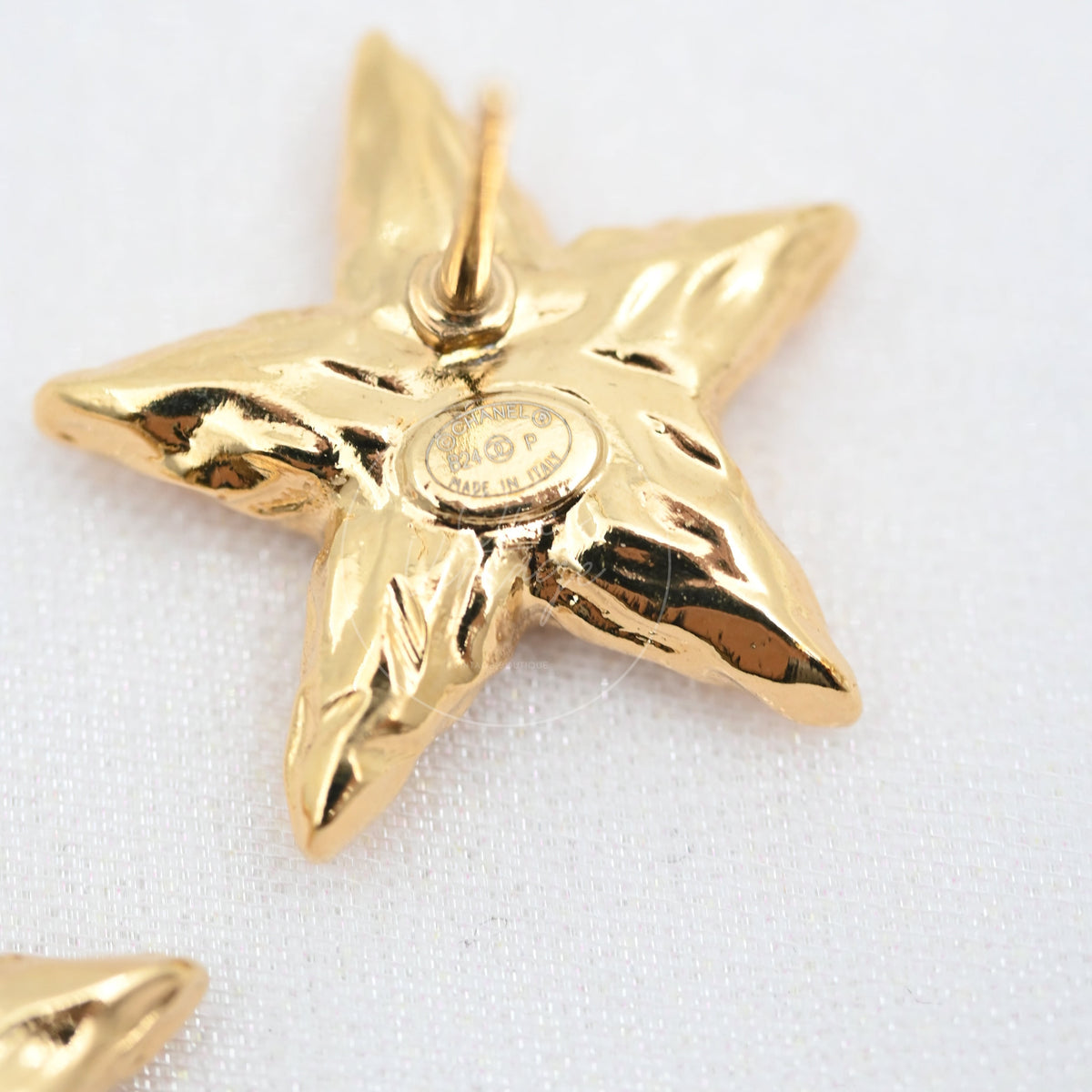 Chanel CC Mark on Gold Lava Star earrings in gold-plated alloy metal, featuring star-shaped earring reverse and circular central marking, back view