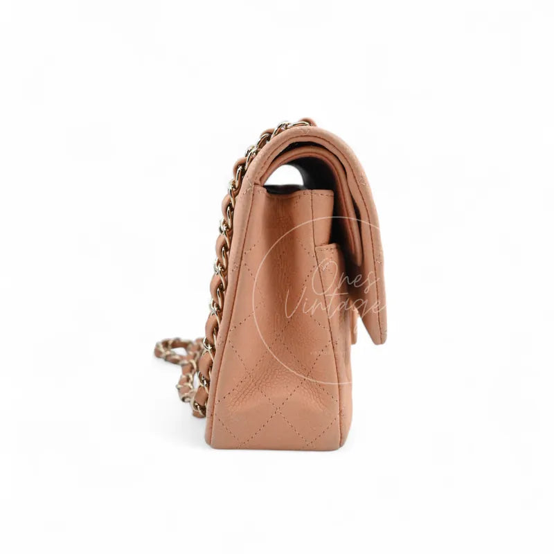 Chanel CF25 Medium Classic Flap Bag in peach caviar with gold-tone hardware, featuring chain strap and flap edge, left side view