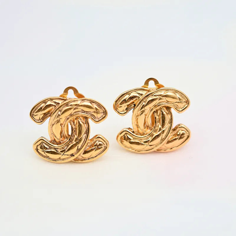 Chanel Vintage CC Earrings Clip-On in gold-plated, featuring interlocking CC motif and ornate textured surface, front view