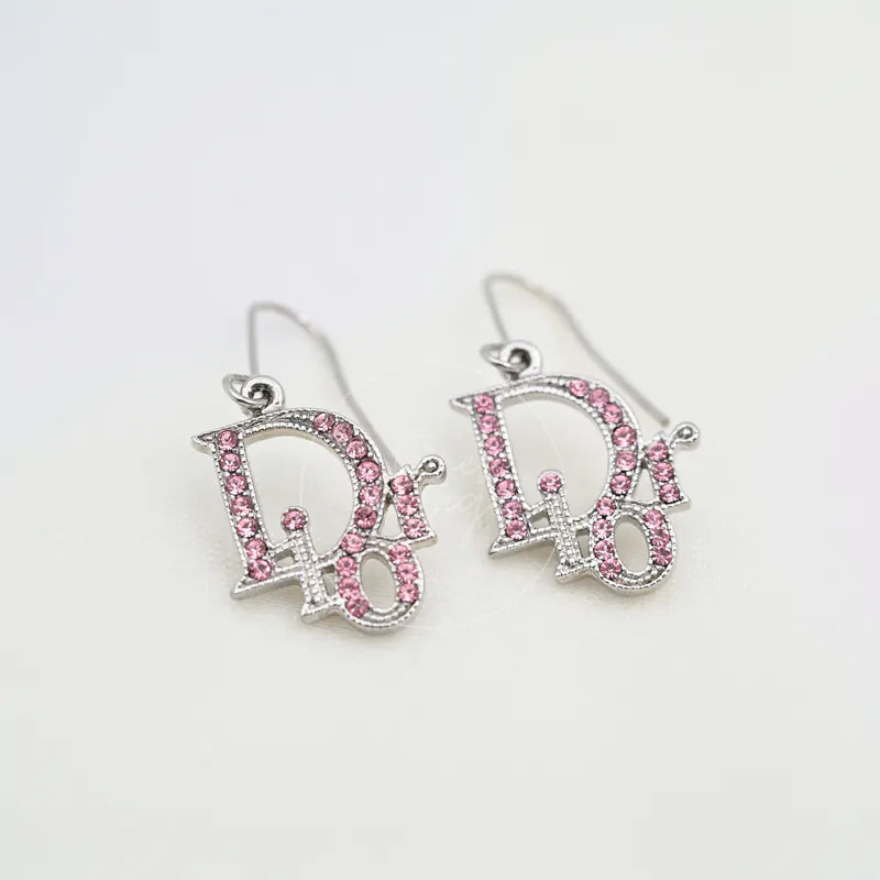 Dior Silver Pink Oblique Pink Rhinestones Earrings in alloy metal, featuring paired dangling earrings and pink rhinestone detailing, front view