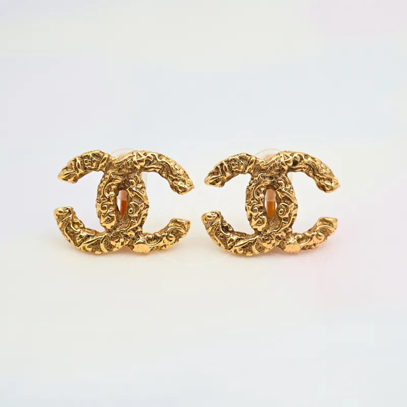 Chanel Vintage Lava CC Mark Ear-clips Earrings in gold-plated metal, featuring matching pair of CC earrings and ornate textured surface, front view