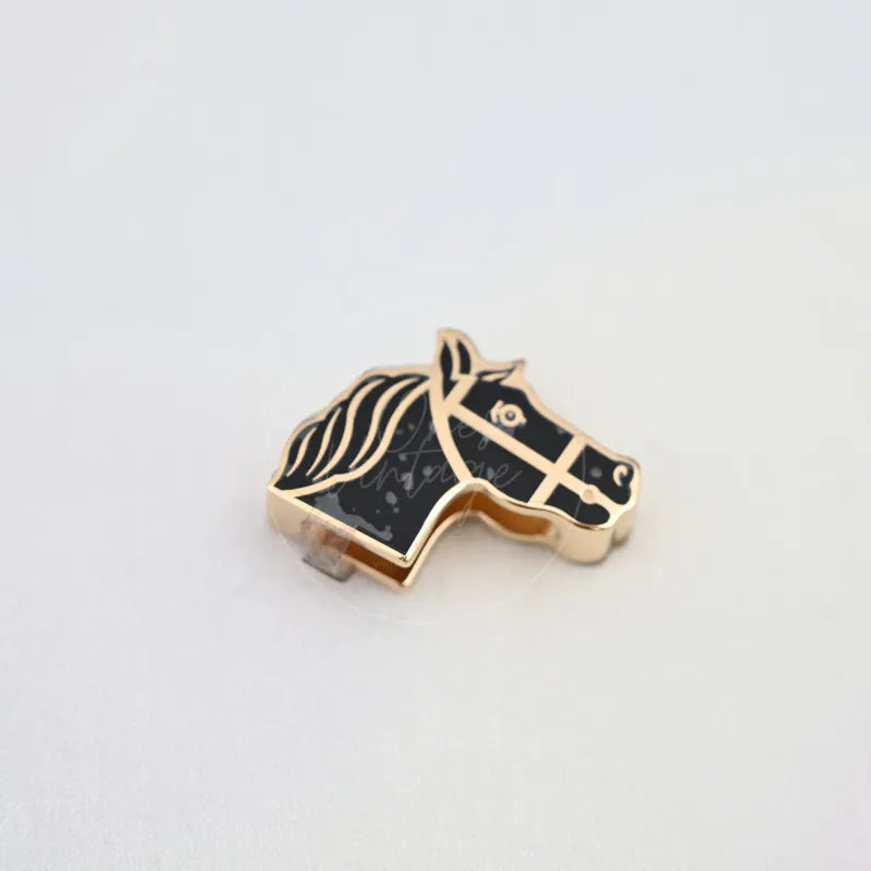 Hermès Quadriage Black & Gold Horse Head Twilly Ring in gold-plated, featuring horse-head silhouette and black patterned face, front view