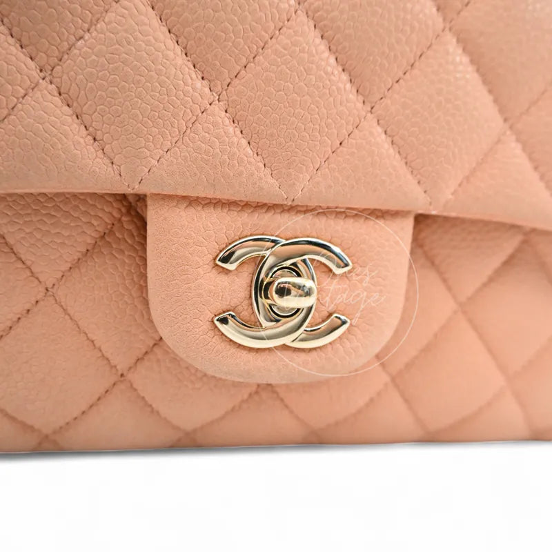 Close-up of Chanel Classic Flap light gold-tone CC turn-lock and Caviar leather texture