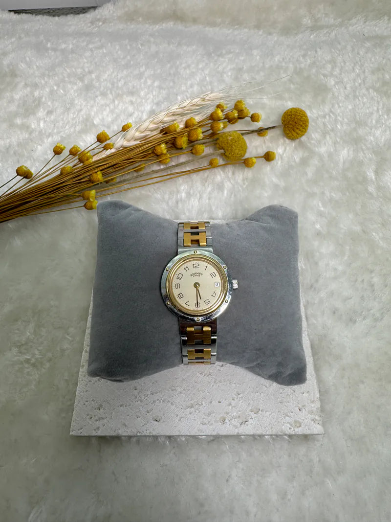 Hermès Classic Clipper watch in stainless steel and gold-plated, featuring cream dial and Roman numeral hour markers, front view