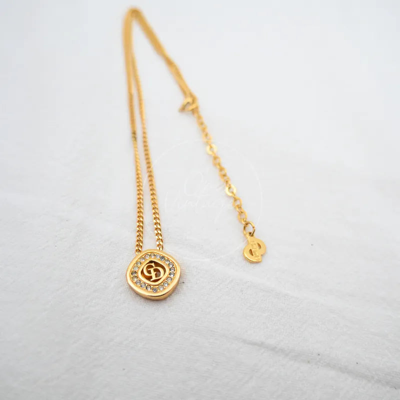 Dior CD-pendant Necklace in plated gold and rhinestone, featuring circular pendant and rhinestone border, front view