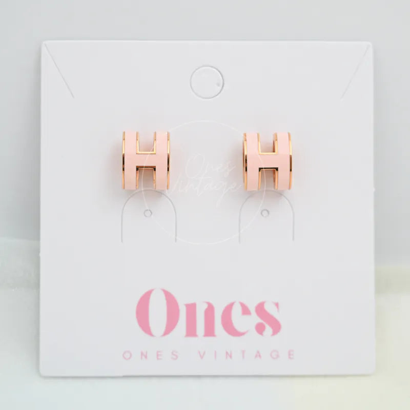 Hermès Pop H Earrings Pink with Pink Gold in gold-plated alloy metal, featuring H-shaped earrings and paired stud earrings, front view