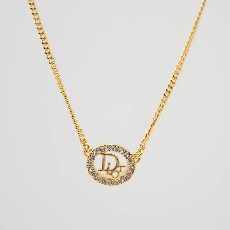 Dior CD Rhinestone Necklace in gold-plated, featuring oval rhinestone surround and central CD monogram, front view