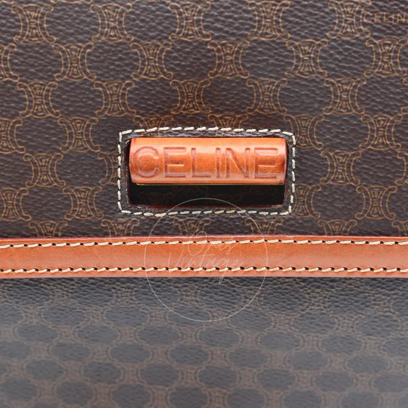 Close-up of debossed CELINE logo on the front leather tab closure of vintage macadam bag
