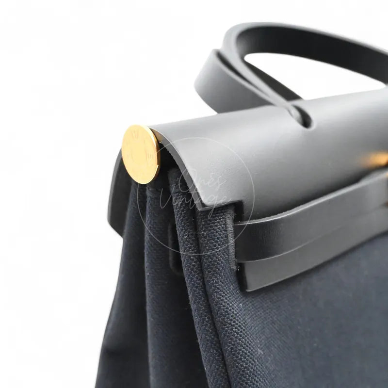 Hermès Herbag Zip 31 Canvas toile canvas and swift, gold-tone round hardware and black leather handle attachment detail