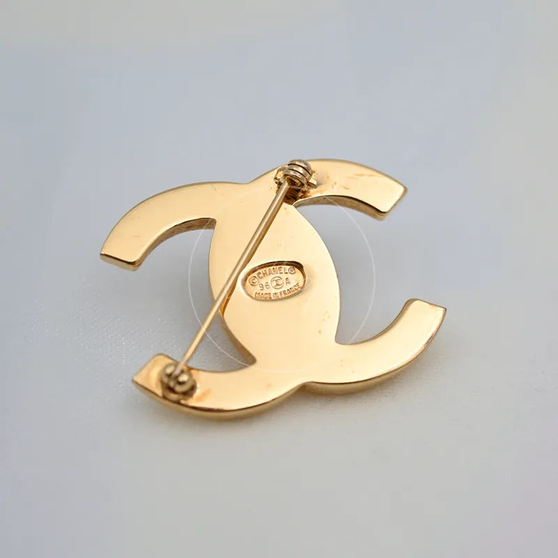 Chanel Vintage CC Logo 24K Plated Brooch in 24K gold-plated, featuring interlocking CC silhouette and safety pin closure, back view