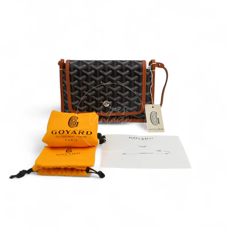 Goyard Plumet Pocket Wallet With Strap in black and tan, featuring front flap with snap closure with attached shoulder strap, front view