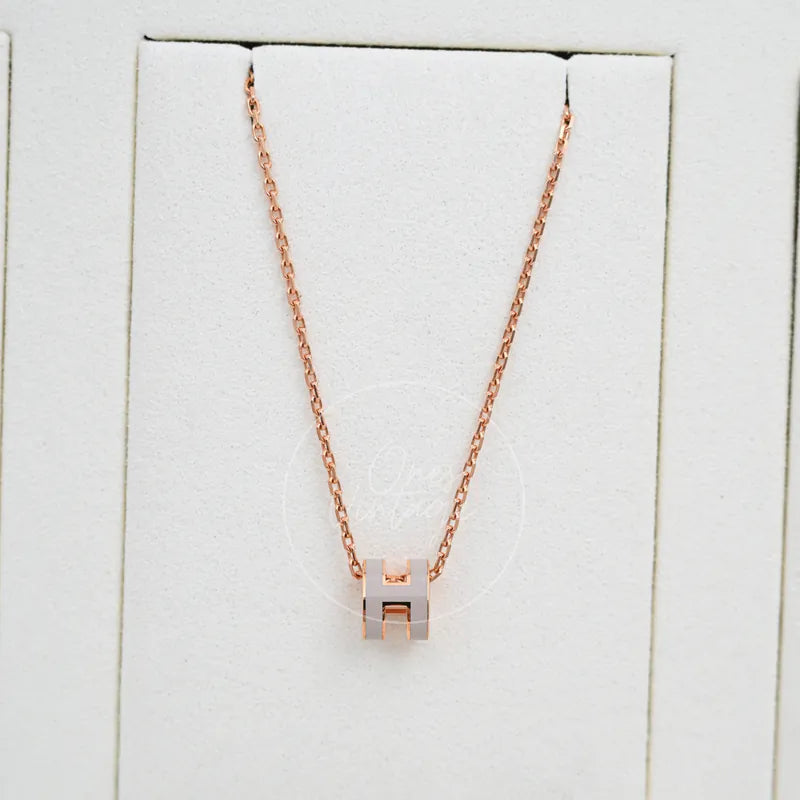 Hermès Mini Pop H Grey Pendant Necklace with Rose Gold in gold-plated alloy metal, featuring geometric pendant and fine link chain, front view