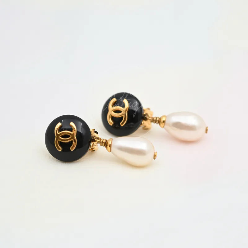 Chanel Teardrop Pearl CC Dangle Earrings in gold-plated, plastic and artificial pearl, featuring black circular CC motifs, front view
