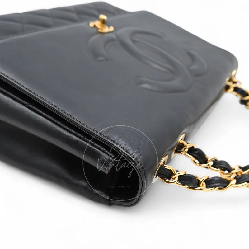 Chanel Vintage Maxi CC Straight Flap Bag in black lambskin, featuring interwoven chain strap and CC motif, front three-quarter view
