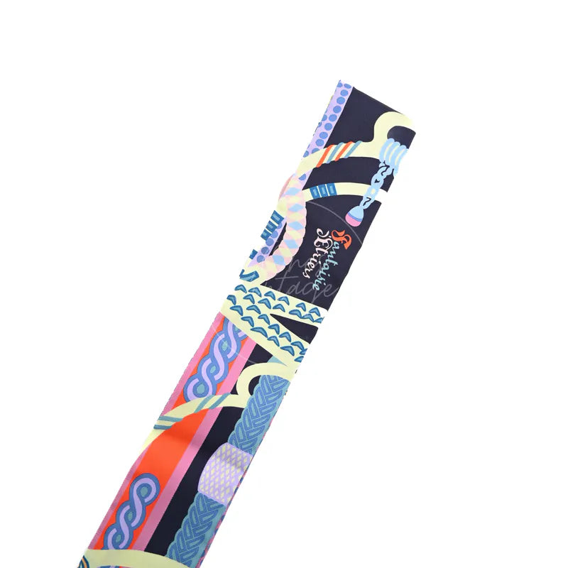 Hermès Fantaisie d'Etriers Twilly in marine, mauve and jaune soufre silk 100%, featuring multicolor equestrian-inspired print, front view