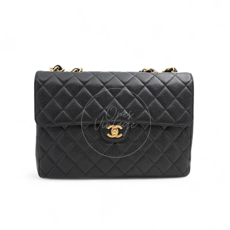 Chanel Jumbo Classic Flap Bag in black caviar with gold-tone hardware, featuring interlocking CC clasp and chain strap, front view