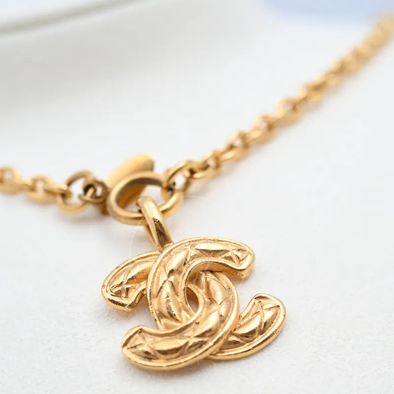 Chanel Matelasse Coco Mark Pendant Necklace, interlocking double-C pendant and textured surface detail
