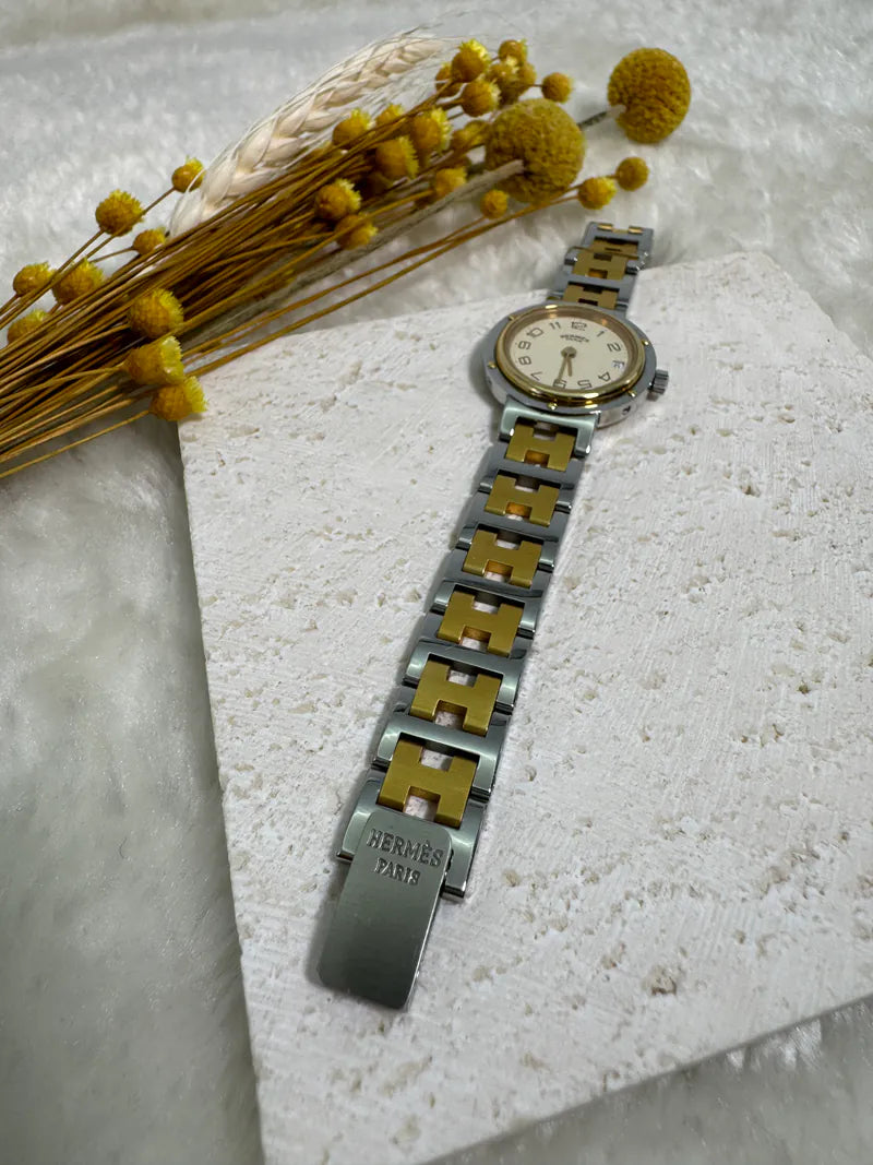 Hermès Classic Clipper watch in stainless steel and gold-plated, featuring folding clasp and Roman numeral hour markers, front view
