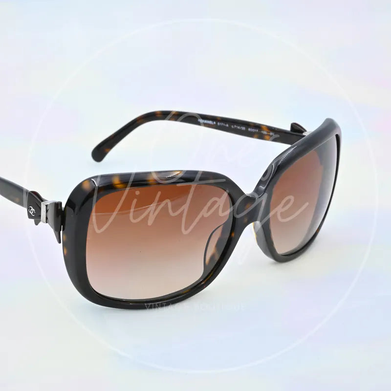 Chanel Sunglasses in black tortoiseshell, featuring oversized square frames and gradient tinted lenses, front three-quarter view