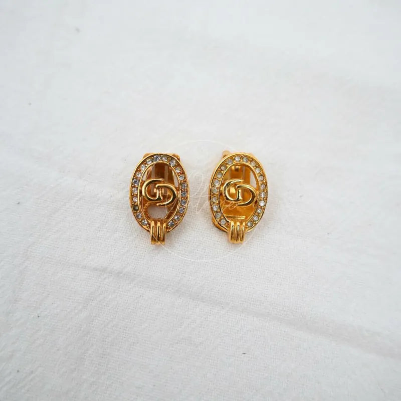 Dior CD Logo Rhinestone Oval Clip Earrings in gold plate, featuring oval rhinestone borders and CD logo motifs, front view