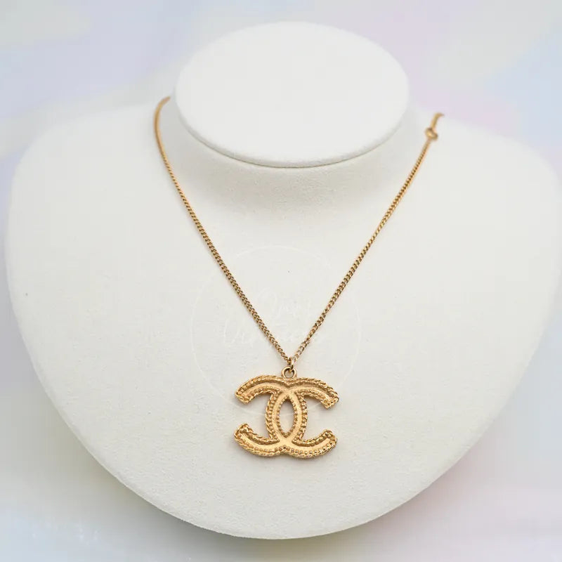 Chanel CC Mark Textured Logo Necklace in gold-plated, featuring interlocking CC pendant and textured rope-like edging, front view