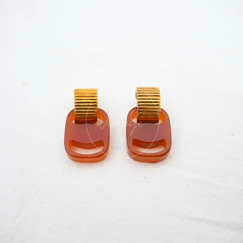 Salvatore Ferragamo Signed Earrings in metal and resin, featuring paired rectangular brown resin drops and ridged gold-tone upper sections, front view