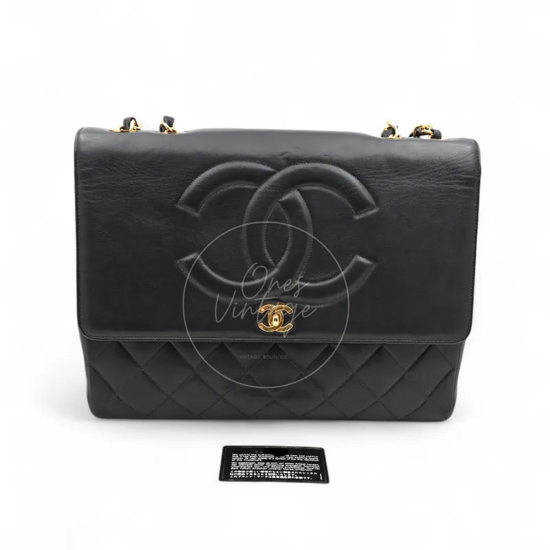 Chanel Vintage Maxi CC Straight Flap Bag in black lambskin with gold-tone hardware, featuring CC turn-lock clasp and chain strap, front view