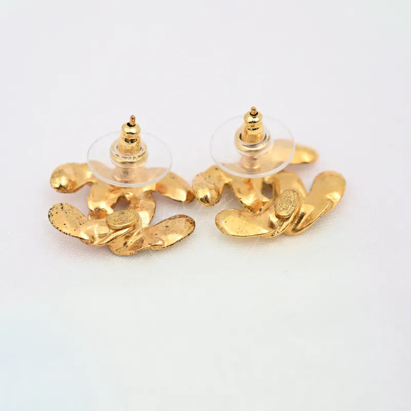 Chanel CC Logo Earrings in gold-plated, featuring post-back earring fittings and sculpted CC logo silhouettes, back view