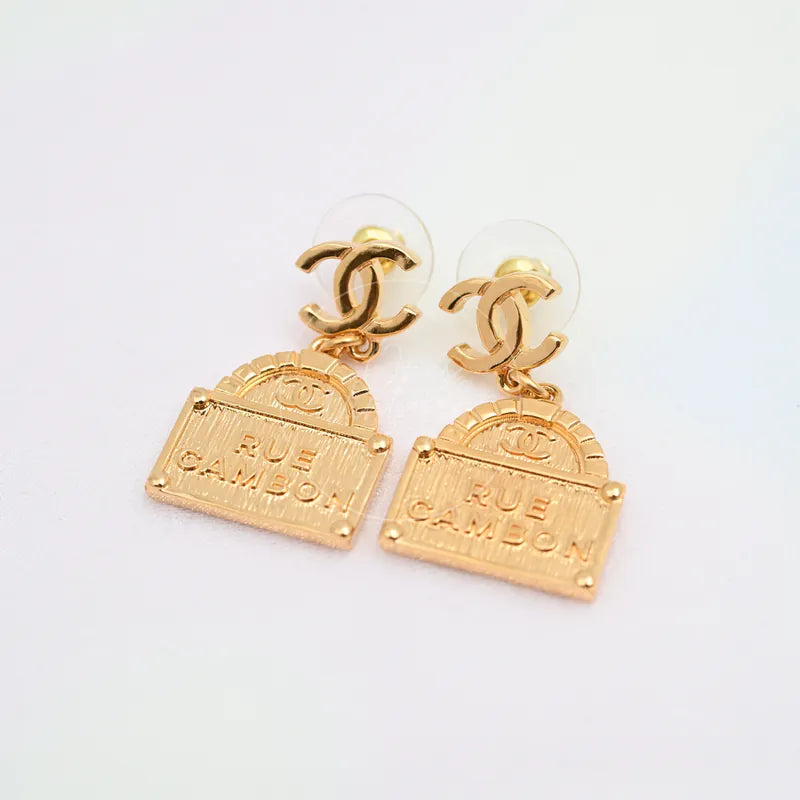 Chanel CC Rue Cambon Drop Earrings in gold-plated, featuring interlocking CC motifs and rectangular Rue Cambon plaques, front view