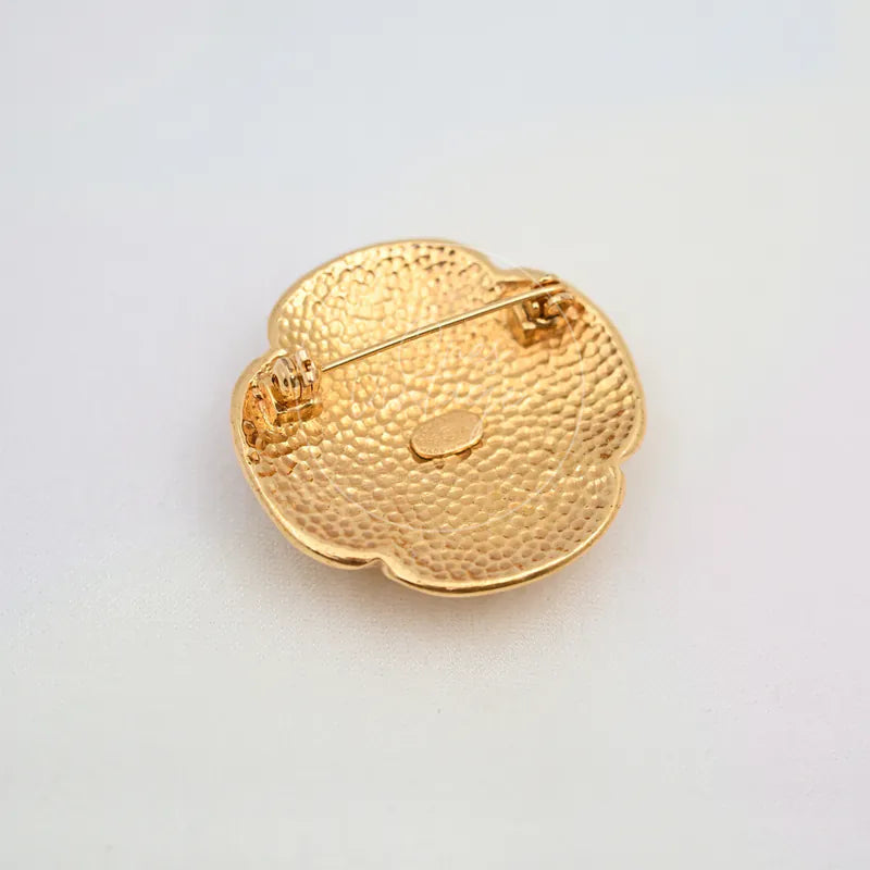 Chanel GP Coco Mark 24K Brooch in 24K gold, featuring pin-back closure and textured metal backing, back view