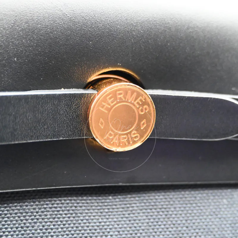 Hermès Herbag Zip 31 Canvas with gold-tone hardware, circular gold-tone clasp and black leather strap detail