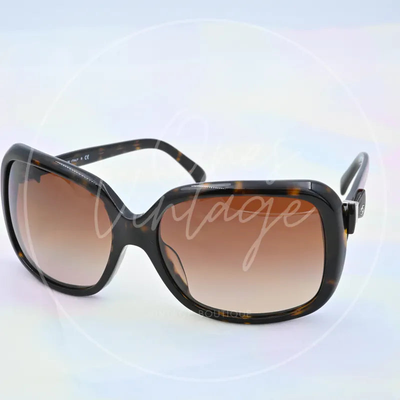 Chanel Sunglasses in black tortoiseshell, featuring oversized rectangular frames and gradient tinted lenses, front three-quarter view