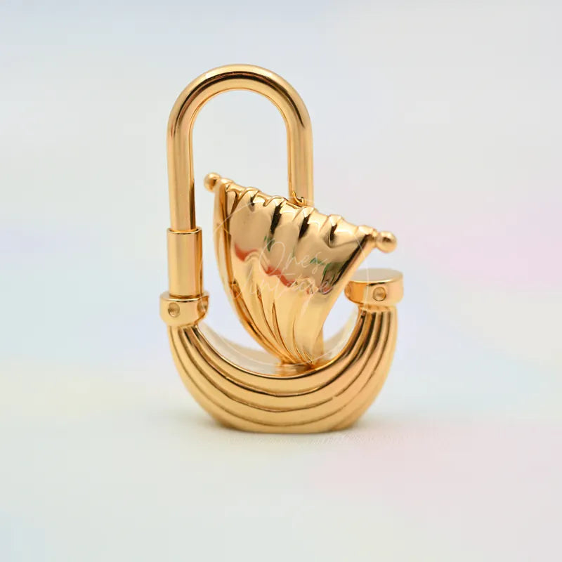 Hermès L'Air De Paris Yacht Cadena Charm in gold, featuring open U-shaped shackle and sailboat-shaped central plate, front view