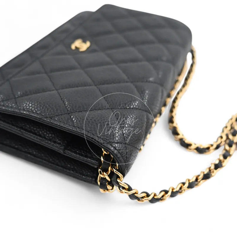 Chanel Wallet on Chain in black quilted caviar leather with gold hardware, Series 22, front right corner