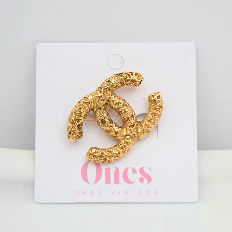 Chanel Vintage CC Mark Brooch in 24K gold-plated, featuring interlocking CC silhouette and ornate scrollwork detailing, front view