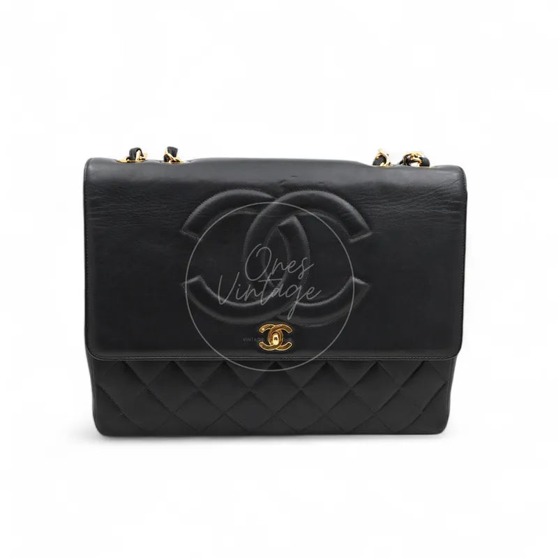 Chanel Vintage flap bag in black lambskin with oversized embossed CC logo and gold hardware