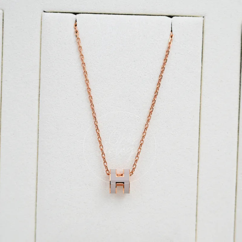 Hermès Grey Rose Gold Mini Pop H Necklace in alloy metal, featuring geometric H-shaped pendant and fine link chain, front view