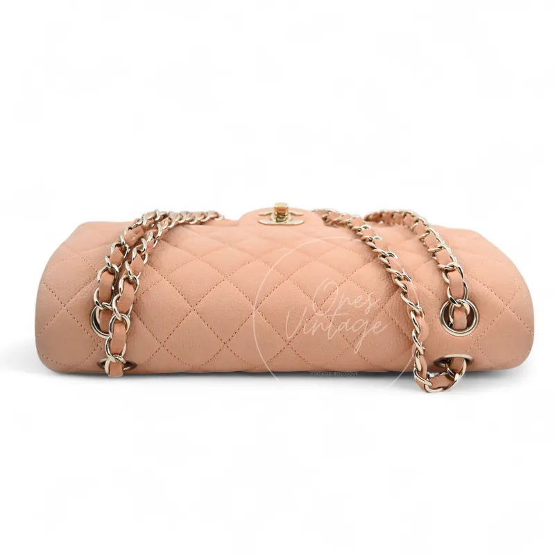 Chanel CF25 Medium Classic Flap Bag in peach caviar with gold-tone hardware, featuring turn-lock clasp and chain strap, front view