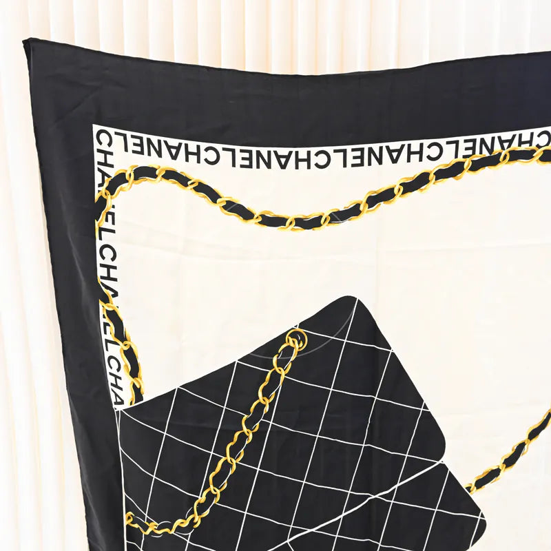 Chanel and Scarf in black and white silk, featuring black-and-white chain print and repeating Chanel text border, front view