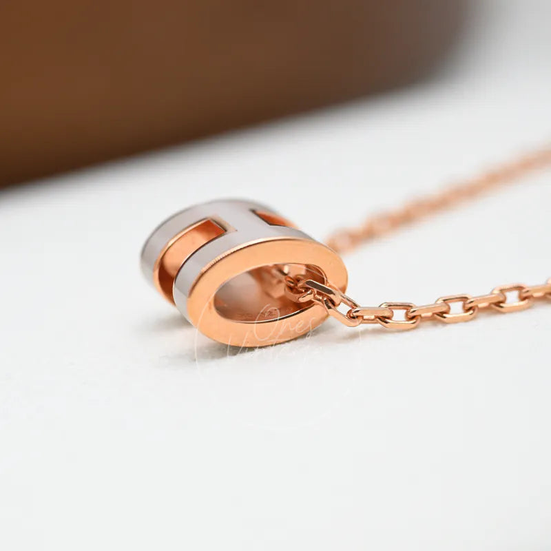 Hermès Mini Pop H Grey Pendant Necklace with Rose Gold, cylindrical pendant and contrasting grey and rose-gold bands detail
