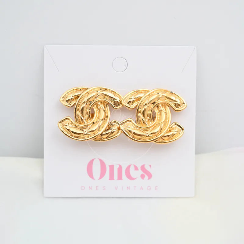 Chanel Vintage CC Earrings Clip-On (Large) in gold-plated, featuring interlocking CC motifs and textured curved ribbon design, front view