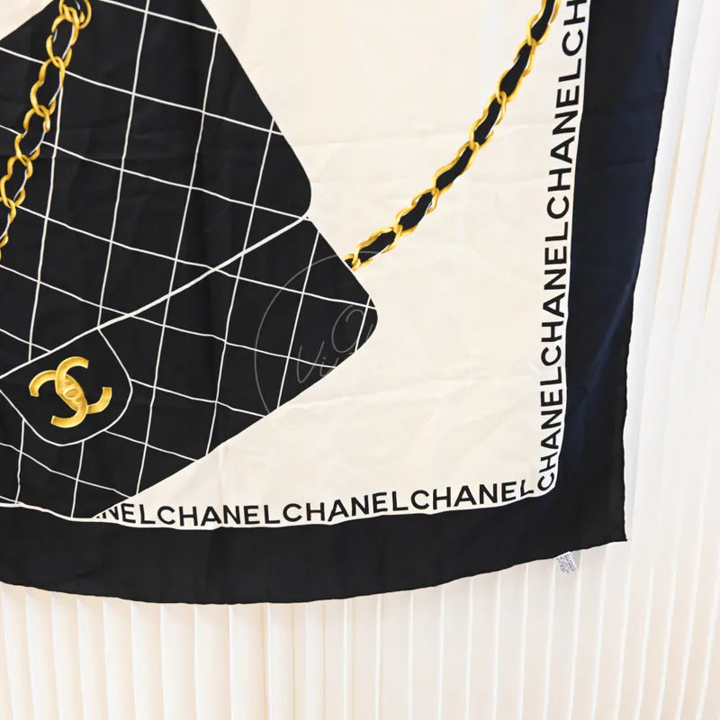 Chanel and Scarf in black and white silk, featuring interlocking CC logo and chain motif, front view
